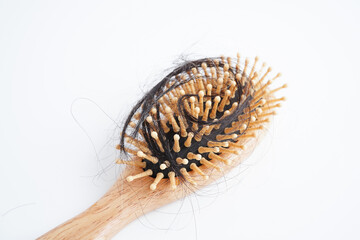 Hair loss fall with comb brush isolated on white background.