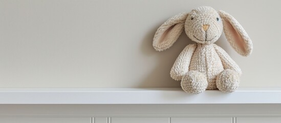 Bunny rabbit toy on baby's shelf. - obrazy, fototapety, plakaty