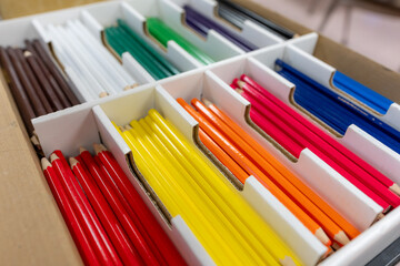 New sorted color pencils within a white box.