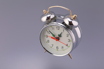 Alarm clock steel retro style gray background shot advertising