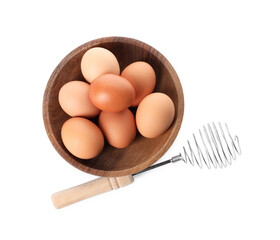Whisk and bowl with raw eggs isolated on white, top view