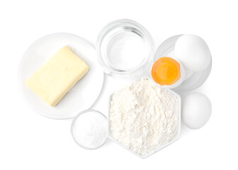 Eggs, butter, flour, salt and water isolated on white, top view. Ingredients for puff pastry dough