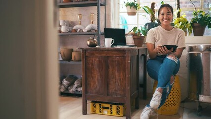 Woman, laptop and pottery studio with entrepreneur, arms crossed and workshop. Small business, craft and hobby for arts and crafts for artisan, happiness and taking notes for startup shopkeeper
