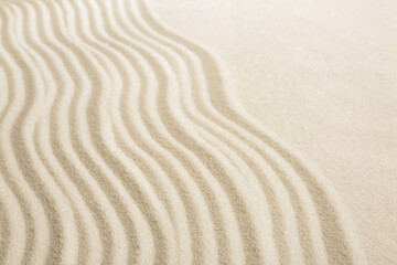 Zen rock garden. Wave pattern on white sand, closeup