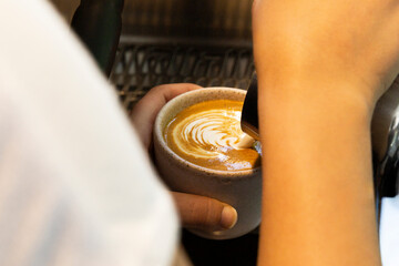Point-of-View of Barista Preparing Latte Art in a White Cup