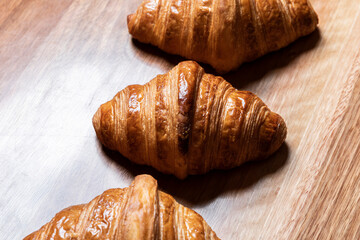 Fresh Croissants Arranging on a Wooden Board
