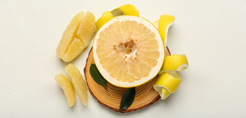 Ripe pomelo on light background, top view