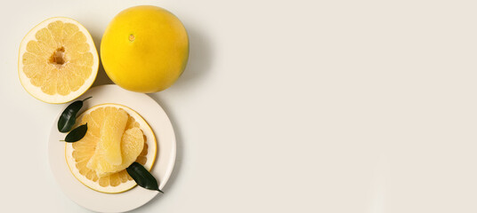 Ripe pomelo on light background with space for text, top view