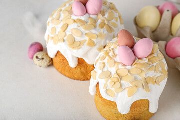 Easter cakes and painted eggs on white background