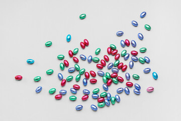 Chocolate Easter eggs in foil on light background