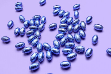 Chocolate Easter eggs on lilac background