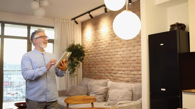 Man adjusting lights at home using smart system