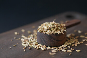 cumin seeds on spoon on table , close up 