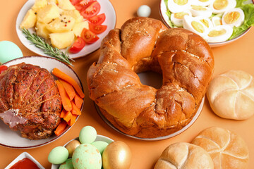 Tasty dishes for Easter dinner on color background, closeup