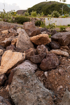 Detailed view of a pile of large rocks removed for paving a road under construction