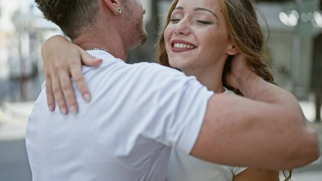 Affectionate couple embracing and smiling on a city street, radiating love and companionship in an urban setting.