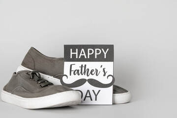 Card for Father's Day with shoes on grey background