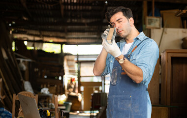 Carpenter working at his carpentry shop. Eyesight is utilized to ensure accuracy.