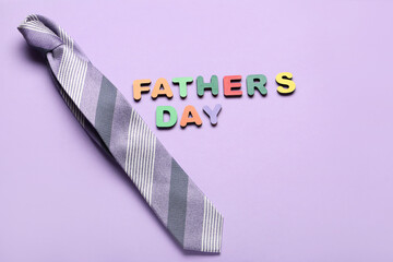 Text FATHER'S DAY with necktie on lilac background