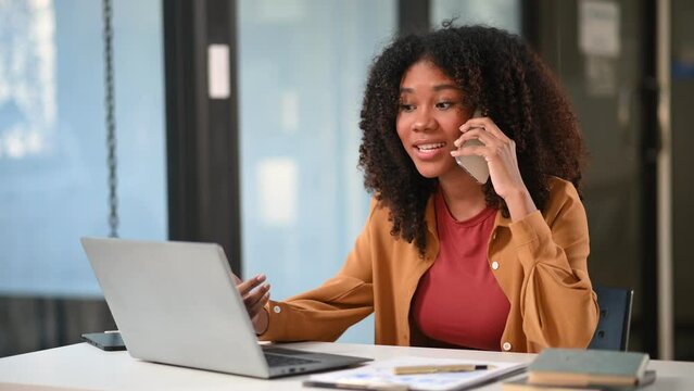 Young business woman working at office with laptop, tablet and taking notes on the paper.