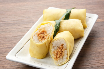 Semar Mendem, made from sticky rice with shredded chicken, wrapped in an omelette or crepe. Indonesian traditional food
