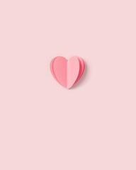 Pink paper heart on pink colored background. Minimal style flat lay, pastel monochrome colors,...