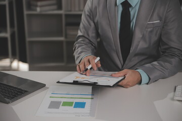 Business team working with new startup project plan and discussion information for financial strategy with laptop and digital tablet in a modern business lounge.