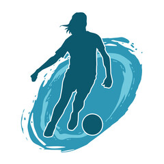 Silhouette of a female soccer player kicking a ball. Silhouette of a football player woman in action pose.