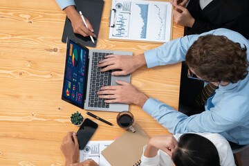 Top view diverse group of business analyst team analyzing financial data report paper on meeting table. Chart and graph dashboard by business intelligence analysis. Habiliment