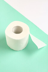 Roll of toilet paper on colorful background