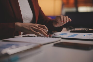 Business woman using calculator for do math finance on wooden desk in office and business working background, tax, accounting, statistics and analytic research concept
