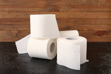 Rolls of toilet paper on black table