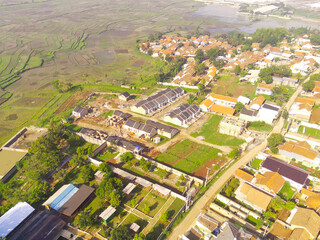 Obraz premium Top view Small Housing. Aerial Photography. Aerial panorama over small isolated housing complex. Shot from a drone flying 200 meters high. Cikancung, Indonesia