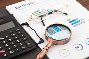 Magnifying glass and glasses on the file