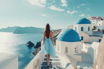 Poster women tourist exploring santorini island in blue dress © Kien
