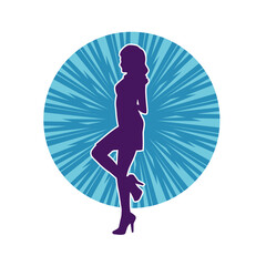 Silhouette of a female dancer wearing mini skirt in action pose. Silhouette of a slim woman dancing happily.