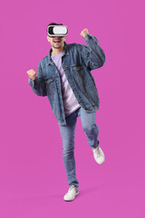 Happy young man in VR glasses on purple background