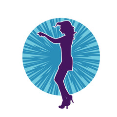 Silhouette of a female dancer wearing mini skirt in action pose. Silhouette of a slim woman dancing happily.