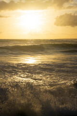 Warm ocean sunset. Sunset dramatic sky on sea. Dreamy fantasy beach, waves splashing. Warm sunlight peaceful, relaxing paradise landscape.