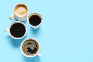 Cups of hot coffee on blue background