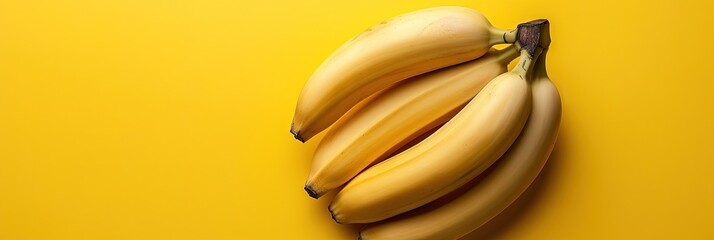 yellow bananas on solid background with copy space