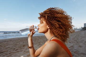 Thirsty Summer: Happy Woman Drinking Water on Sunny Beach, Enjoying Vacation