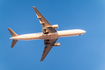 Airplane before landing in blue sky, Airbus A330