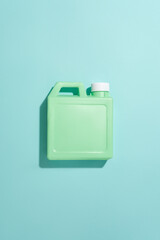 Top view of a bottle of detergent isolated on a blue background. Mockup of house cleaning products. Commercial images for advertising with blank label.