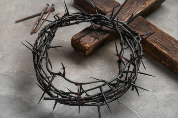 Fototapeta na wymiar Crown of thorns with wooden cross and nails on grey grunge background