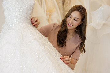 Portrait young Asian woman looking white wedding dress