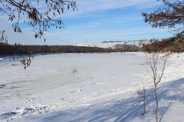 The lake is covered in ice in winter, everything is covered in snow