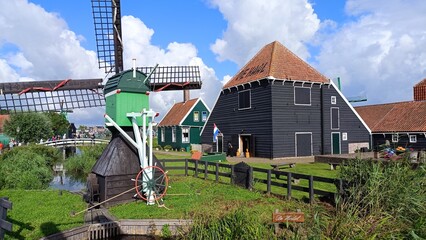Zaanse Schans is a neighborhood in the Dutch town of Zaandam, near Amsterdam. Historic windmills and distinctive green wooden houses were relocated here to recreate the look of an 18th/19th-century vi