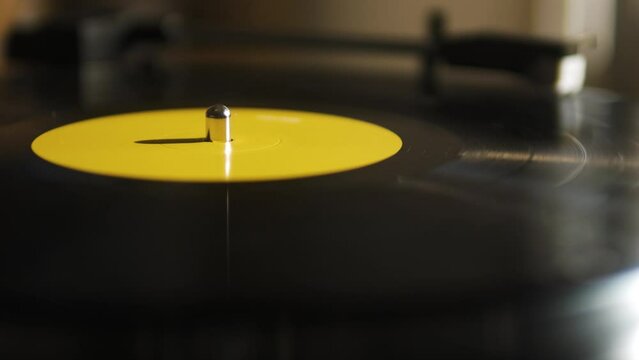 Close Up of a Yellow Spinning Vinyl on a Record Player