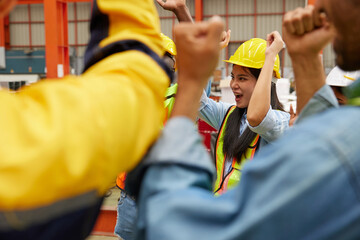 group of engineers and technicians raise hands for success work and project in the factory